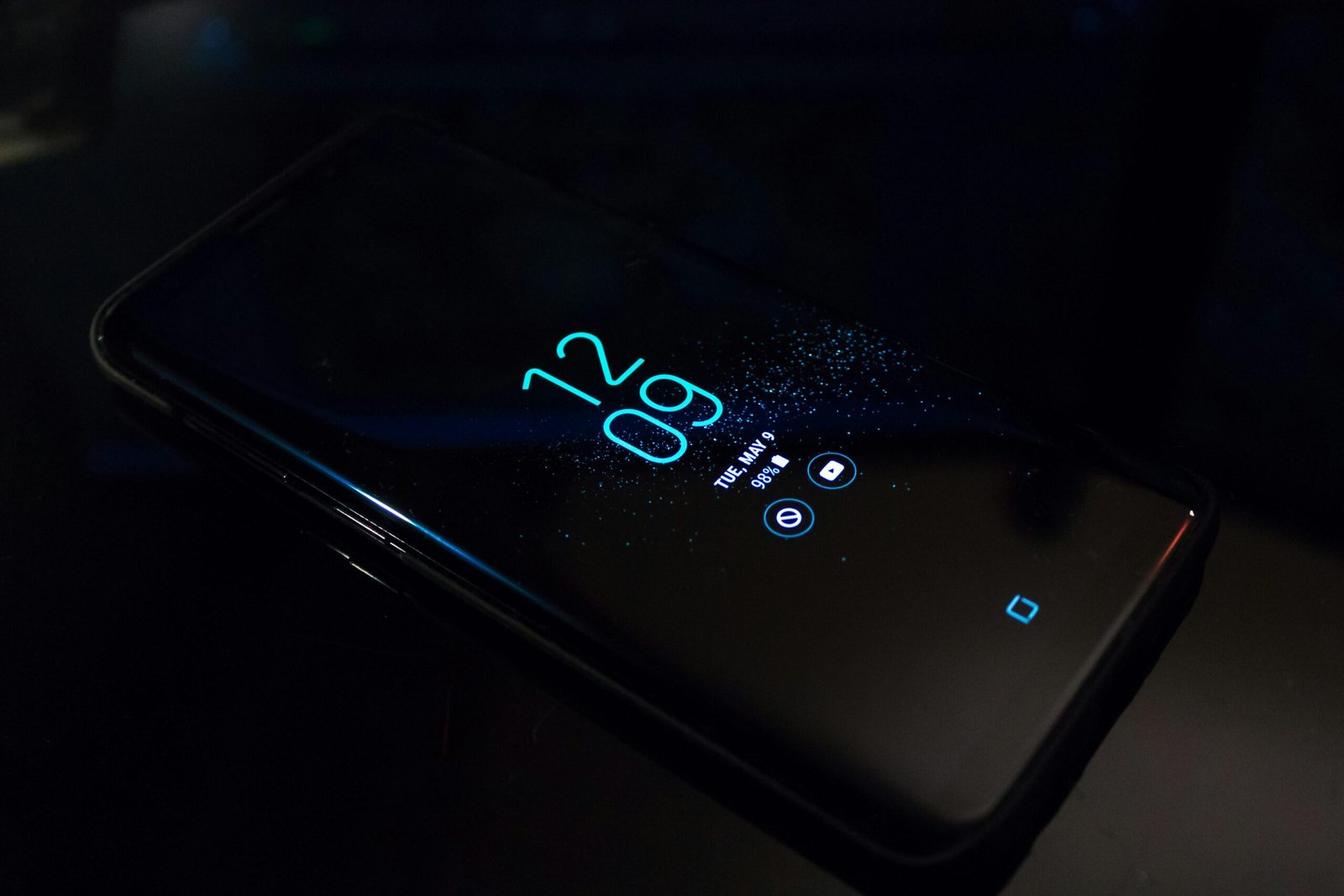 pexels-photo-404280-404280 Close-up of a smartphone in the dark displaying digital clock and notifications.